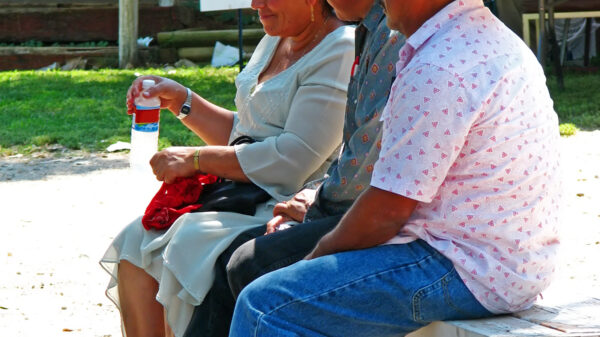 3 people sitting on a bench
