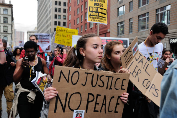Image of protesters with no justtice no peace sign