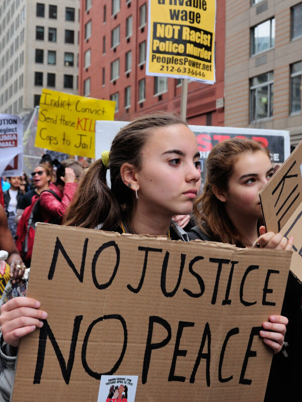 Image of protesters with no justtice no peace sign