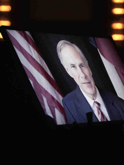 Greg Abbott on TV monitor screen
