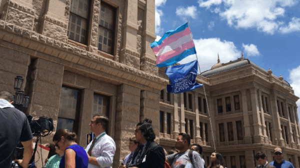 trans flag flying outside of the Texas Capitol