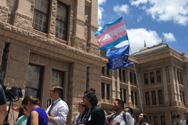 trans flag flying outside of the Texas Capitol