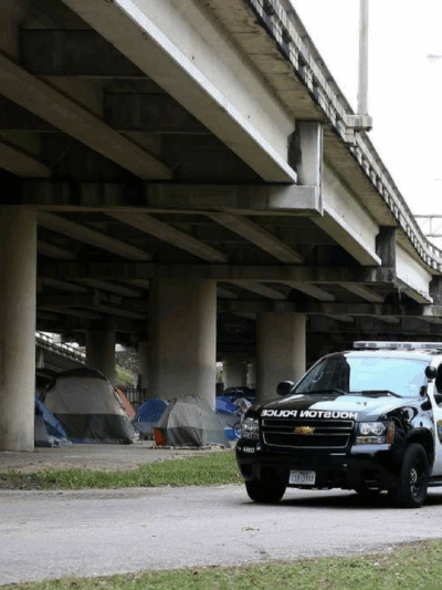 Houston police outside of homeless encampment.
