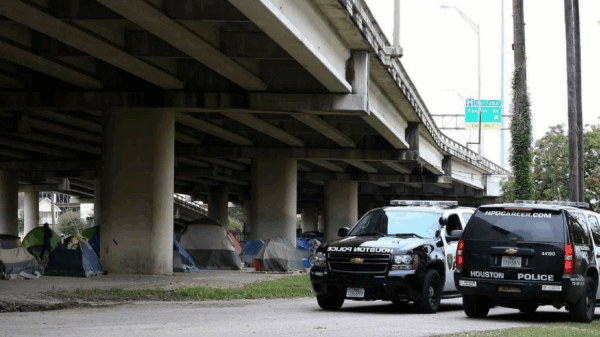 Houston police outside of homeless encampment.