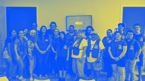 Image: A group people wearing vests that say 'ACLU of Texas Legal Observer' pose for the camera. Below them text reads Dallas Legal Observer Training / Union Coffee Dallas 3705 Cedar Springs Rd / November 16 | 2- 3:30pm.