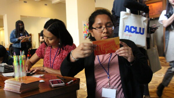Image: RFIA attendees fill out postcards for their state legislators, writing in support of abortion access