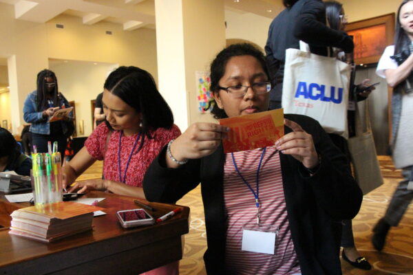 Image: RFIA attendees fill out postcards for their state legislators, writing in support of abortion access