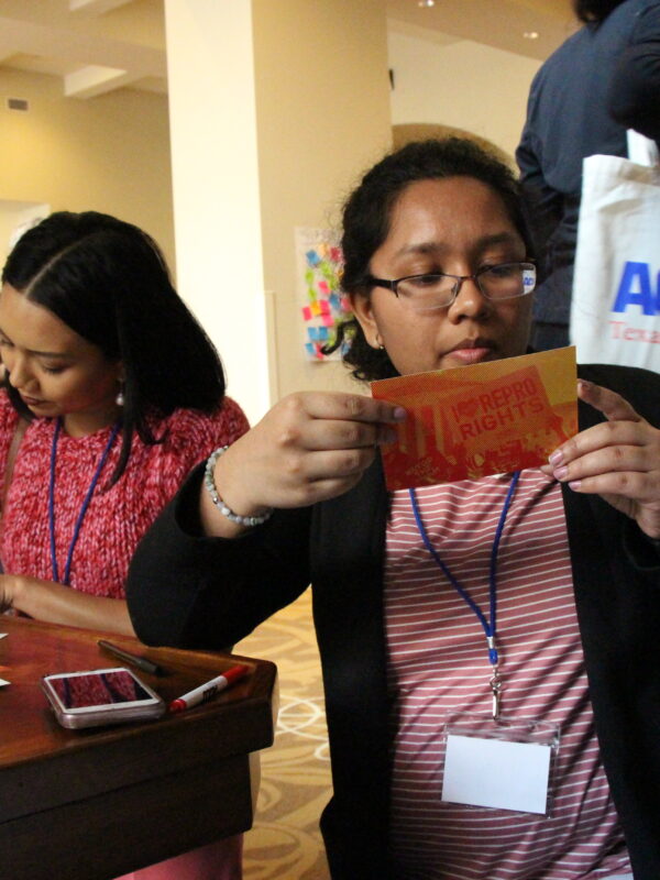 Image: RFIA attendees fill out postcards for their state legislators, writing in support of abortion access