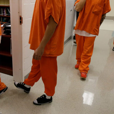 People in detention orange outfit
