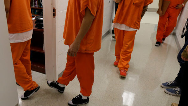 People in detention orange outfit