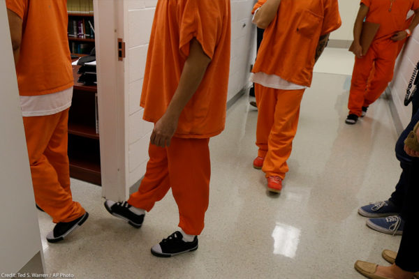 People in detention orange outfit