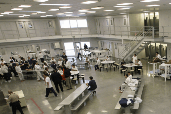 Detained young men in a large dorm room