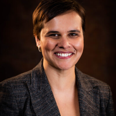 Image: A photo shows Sarah Labowitz posing for the camera in front of a solid background.
