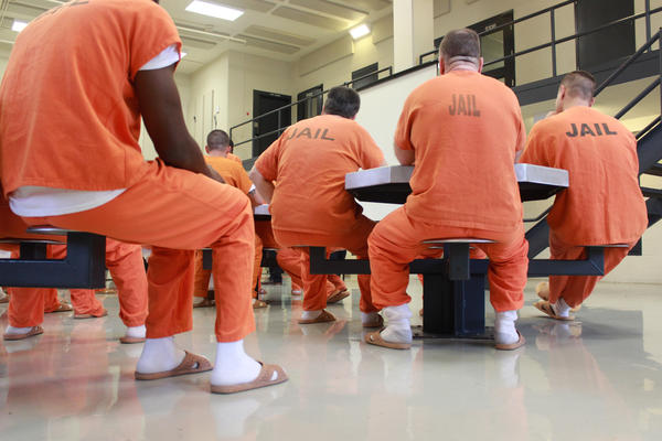 People in orange jail jumpsuits