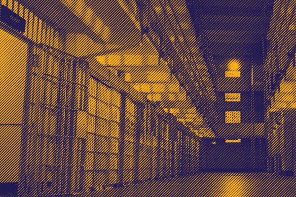 Image: A stylized photo shows the inside multi-level carceral facility, with cells lining the walls..