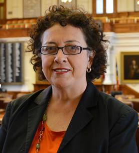 Photo: Texas House Representative Celia Israel poses for a portrait. Visible behind her is the interior of the Texas House chamber in the state capitol.