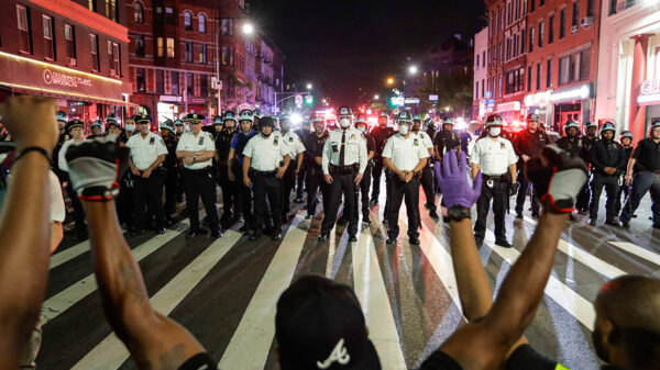 Protesters take a knee on Flatbush Avenue in front of New York City police officers during a solidarity rally for George Floyd