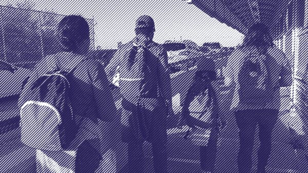 Image: A stylized photo shows a family, their backs to the camera, carrying backpacks and walking along the international bridge between Matamoros in Mexico and Brownsville, TX. 