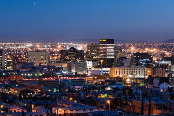 Photo: The El Paso skyline is lit up, with a dusky sunset in the horizon.