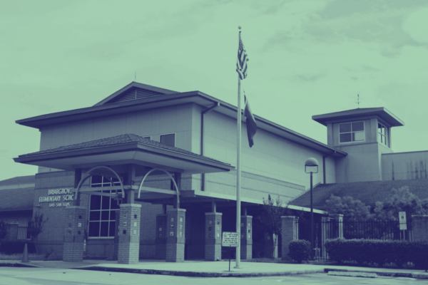 Image: A stylized photo shows a school building with a flag pole in front.