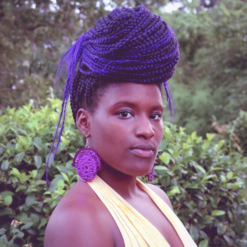 Photo: CoWanda Rusk poses in front of foliage outside