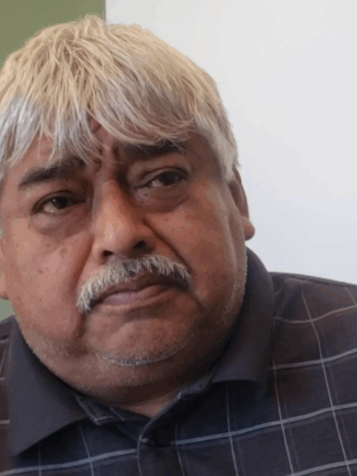 Photo: Roman Vasquez sits and stares into the distance.