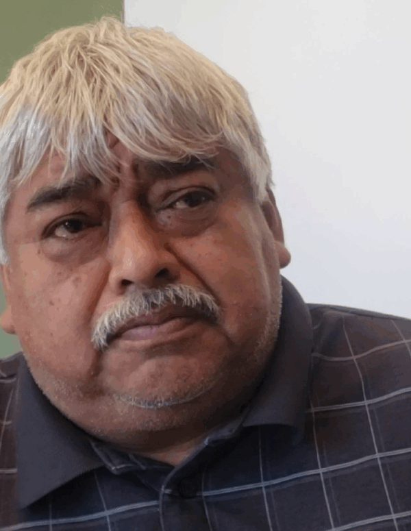 Photo: Roman Vasquez sits and stares into the distance.