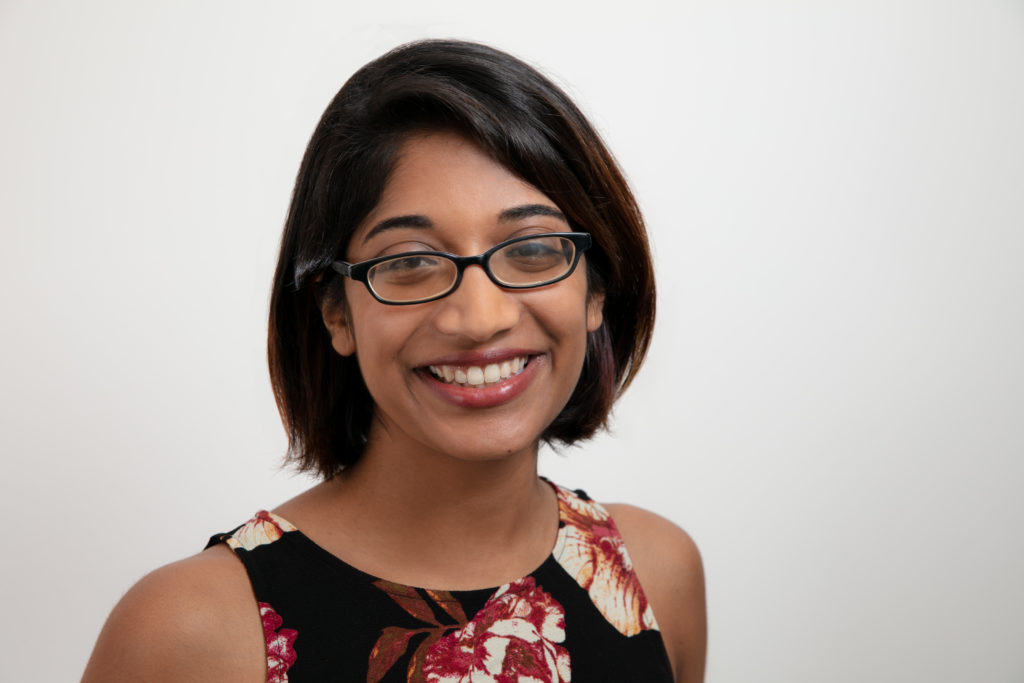 Photo: Rosann Mariappuram poses for a photo in front of a solid background