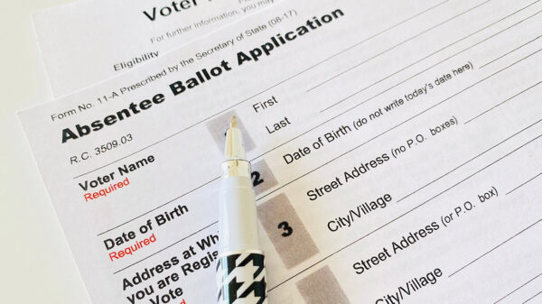 Photo: A paper application for absentee ballot is shown.