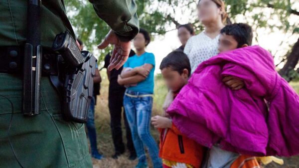 A Customs and Border Protection officer questions immigrants in Rio Grande Valley sector of the Texas border on Aug. 20, 2019.