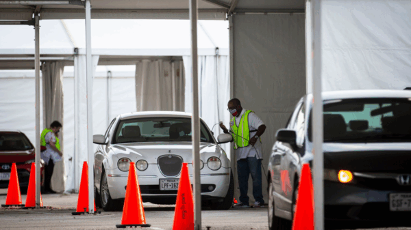 Cars line up during the pandemic to vote by drive-thru