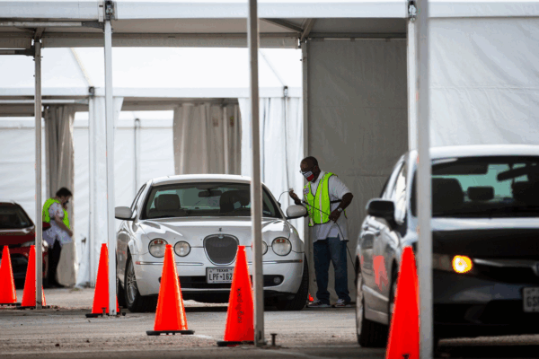 Cars line up during the pandemic to vote by drive-thru