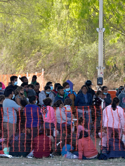 Migrants in custody at U.S. Customs and Border Protection processing area under the Anzalduas International Bridge, Friday, March 19, 2021, in Mission, Texas.