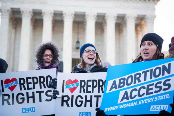 People holding pro-abortion signs in front of the Supreme Court