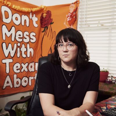 Image: Blair Wallace poses for a photo. Foliage is visible behind her.