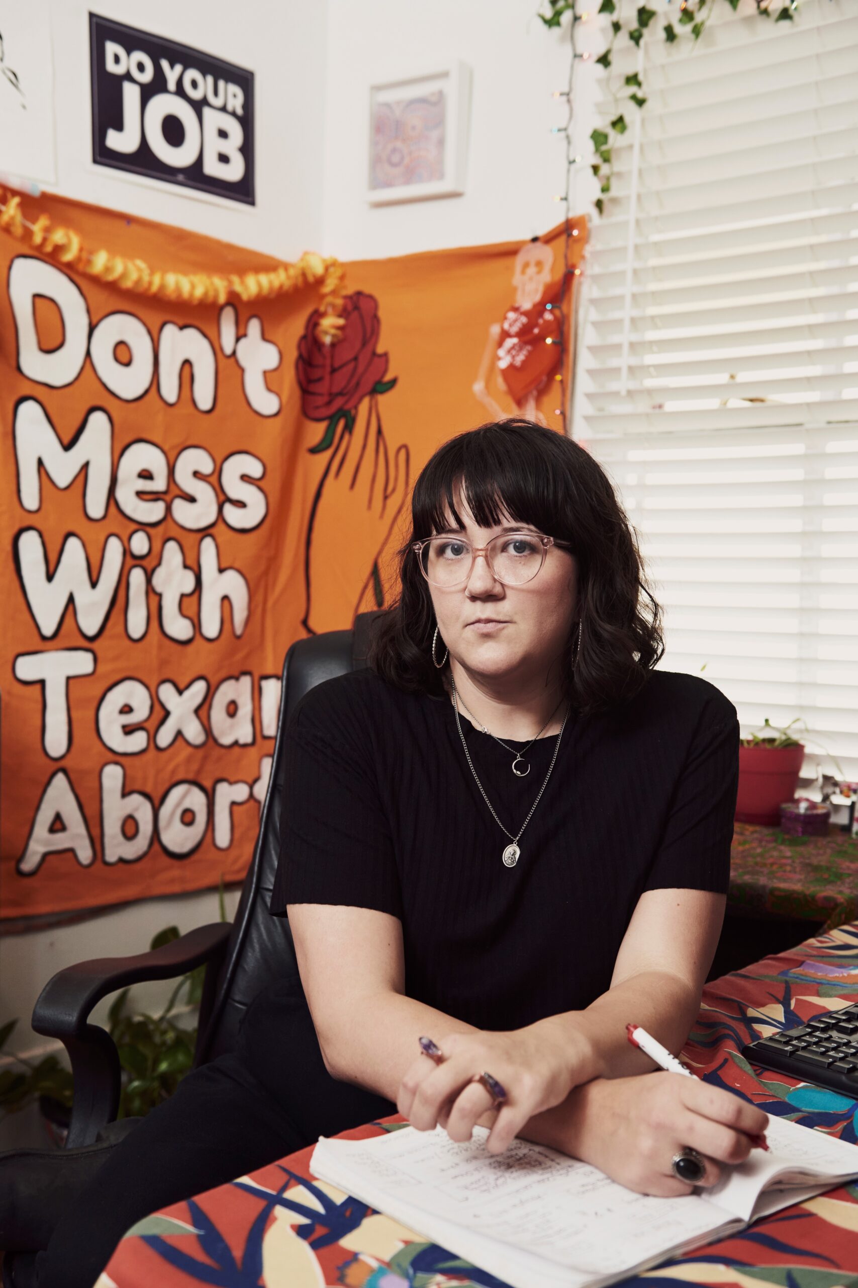 Image: Blair Wallace poses for a photo. Foliage is visible behind her.