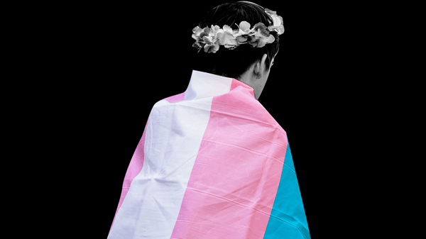 youth wearing a transgender flag