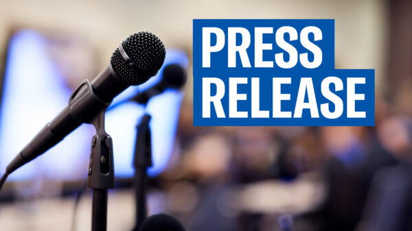 Photo of a microphone next to the phrase "Press Release"