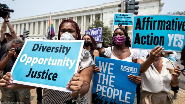 Protesters in front of the Supreme Court hold signs that read, "Diversity, Opportunity, Justice", "ACLU, WE THE PEOPLE", "Affirmative Action YES!" and "Asians for Affirmative Action".
