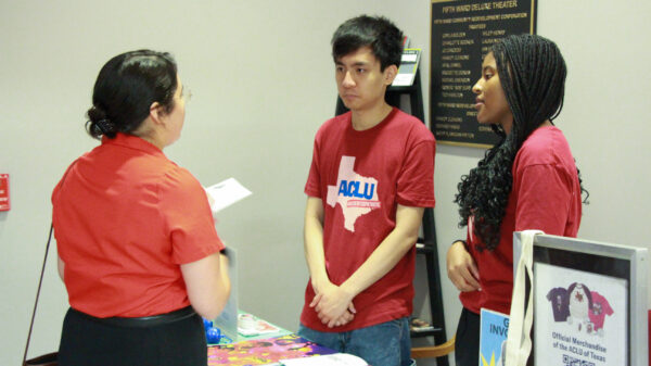 image of two people tabling and wear an aclu of tx t shirt
