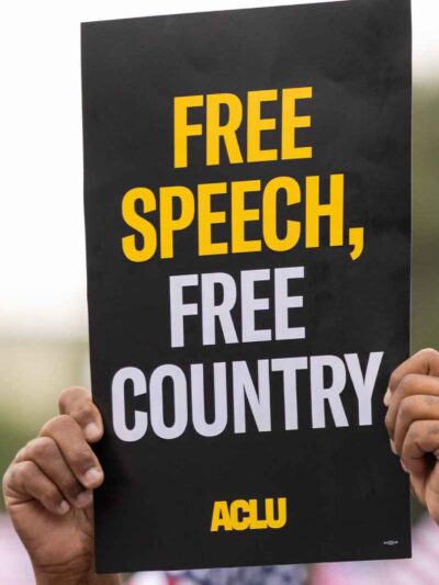 Close up photo of an ACLU protest sign that reads "Free Speech, Free Country"