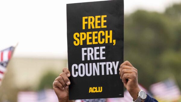 Close up photo of an ACLU protest sign that reads "Free Speech, Free Country"