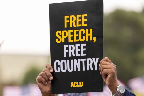 Close up photo of an ACLU protest sign that reads "Free Speech, Free Country"
