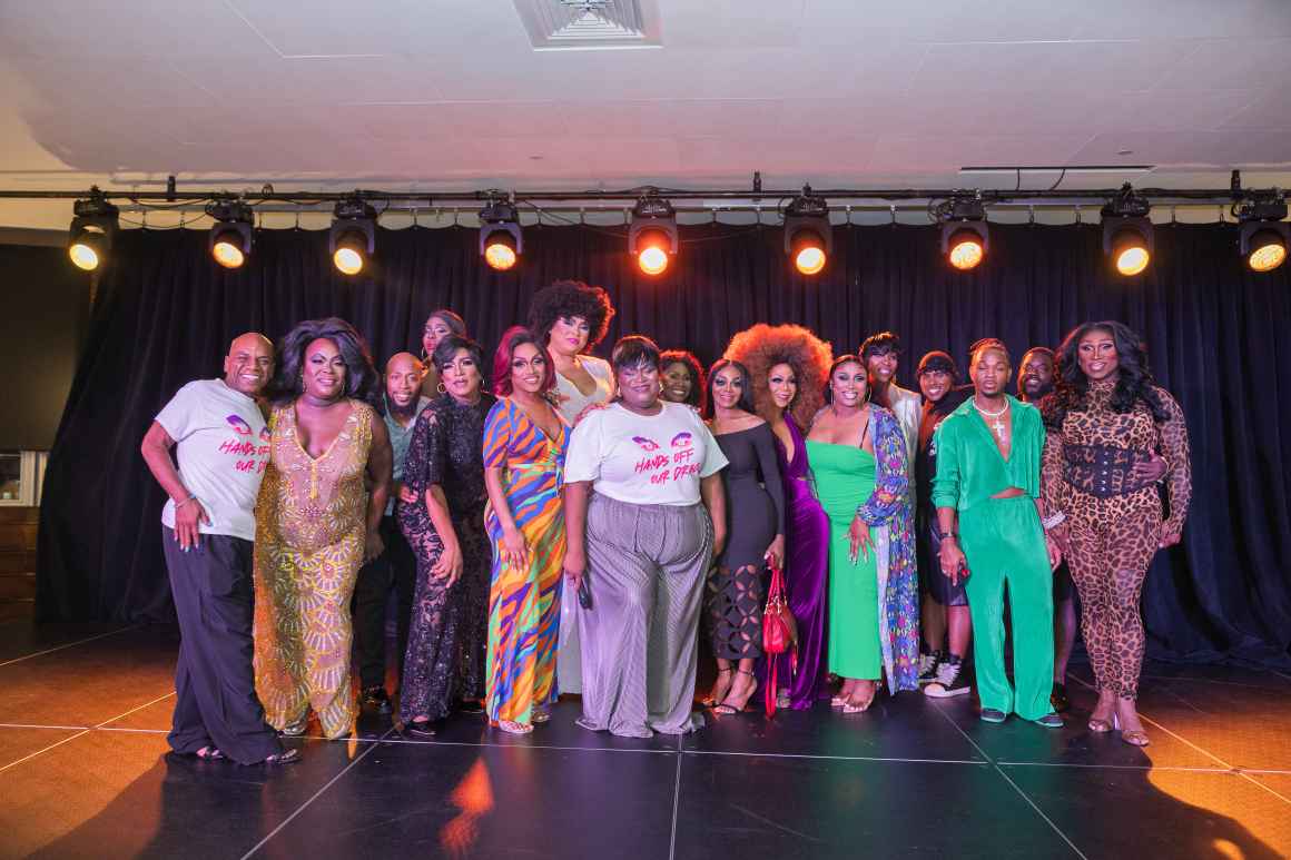 Photo of a group of Black trans Texans standing together on a stage.