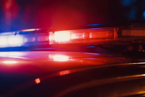 Close-up photo of the red and blue lights on top of a police car