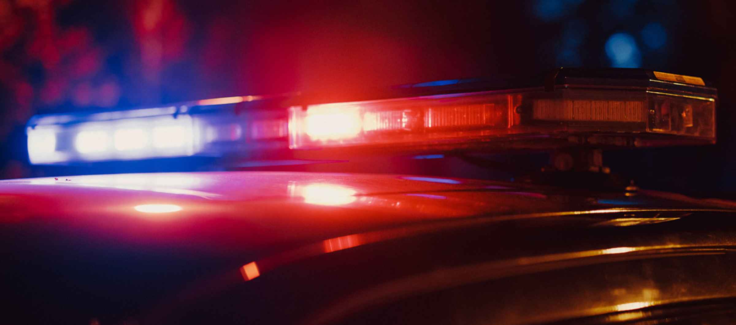 Close-up photo of the red and blue lights on top of a police car