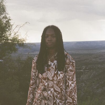 Image of Dr. Robyn B. Adams in front of nature landscape.