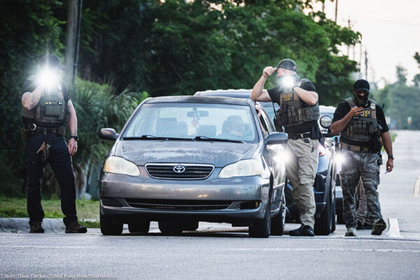 ICE agents temporarily halting a driver.