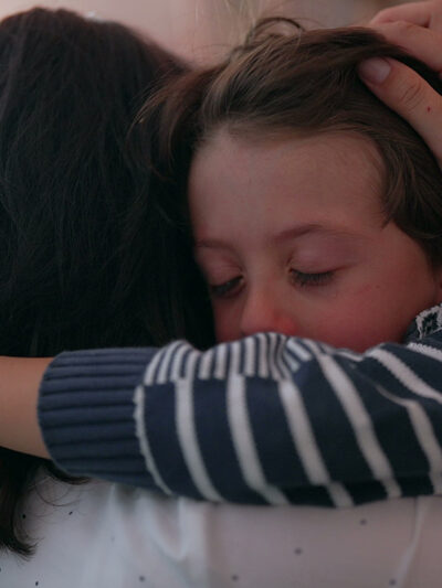 Mother comforting crying child.