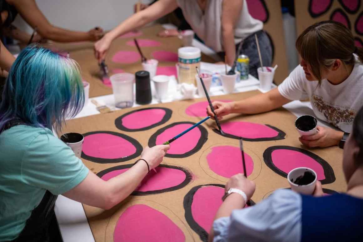 People work together to build puppets for an immigrants' rights rally against SB4